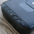 Closeup of a textured biometric safe keypad with numbered buttons on a wooden surface