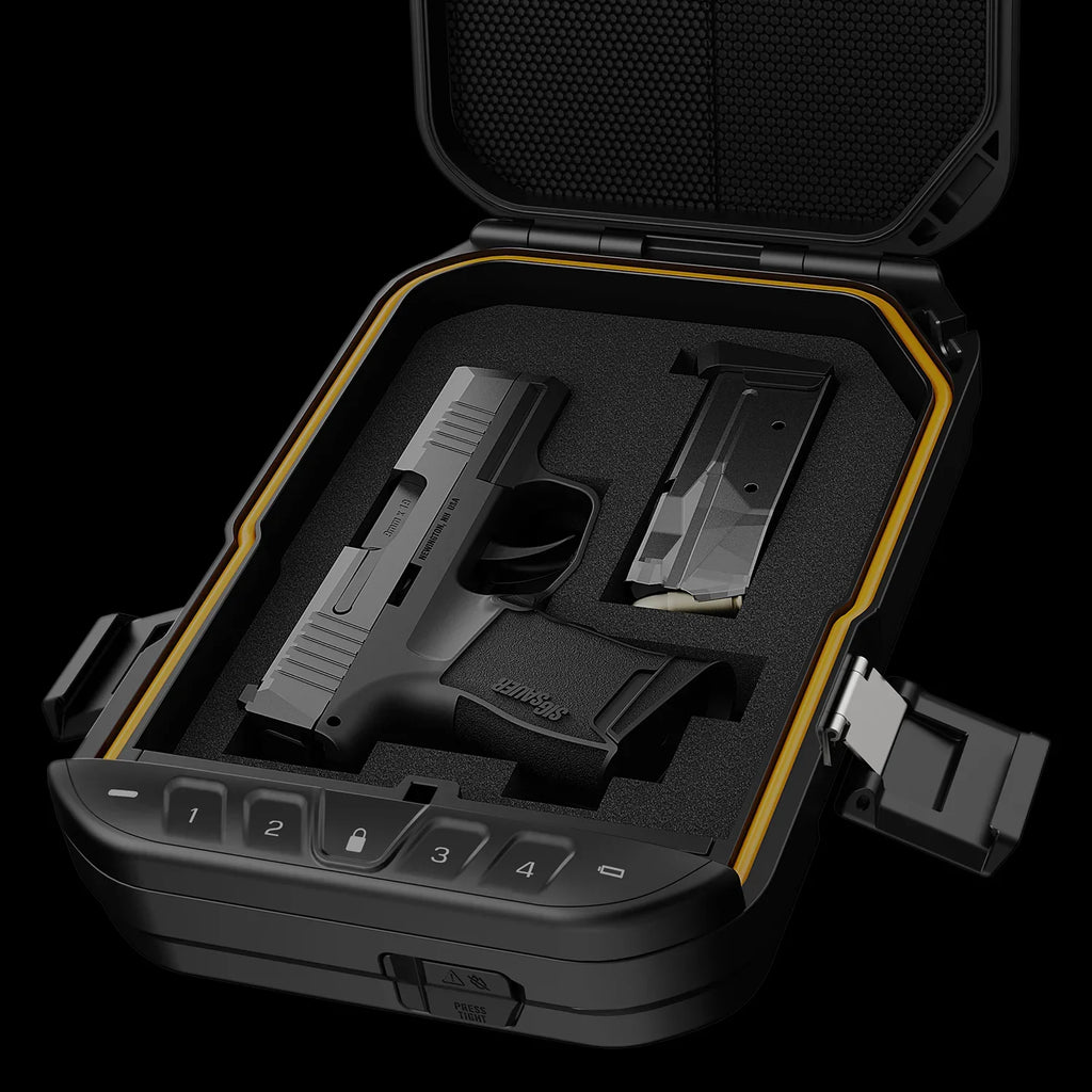 Open biometric gun safe with keypad, holding a compact handgun and an extra magazine.