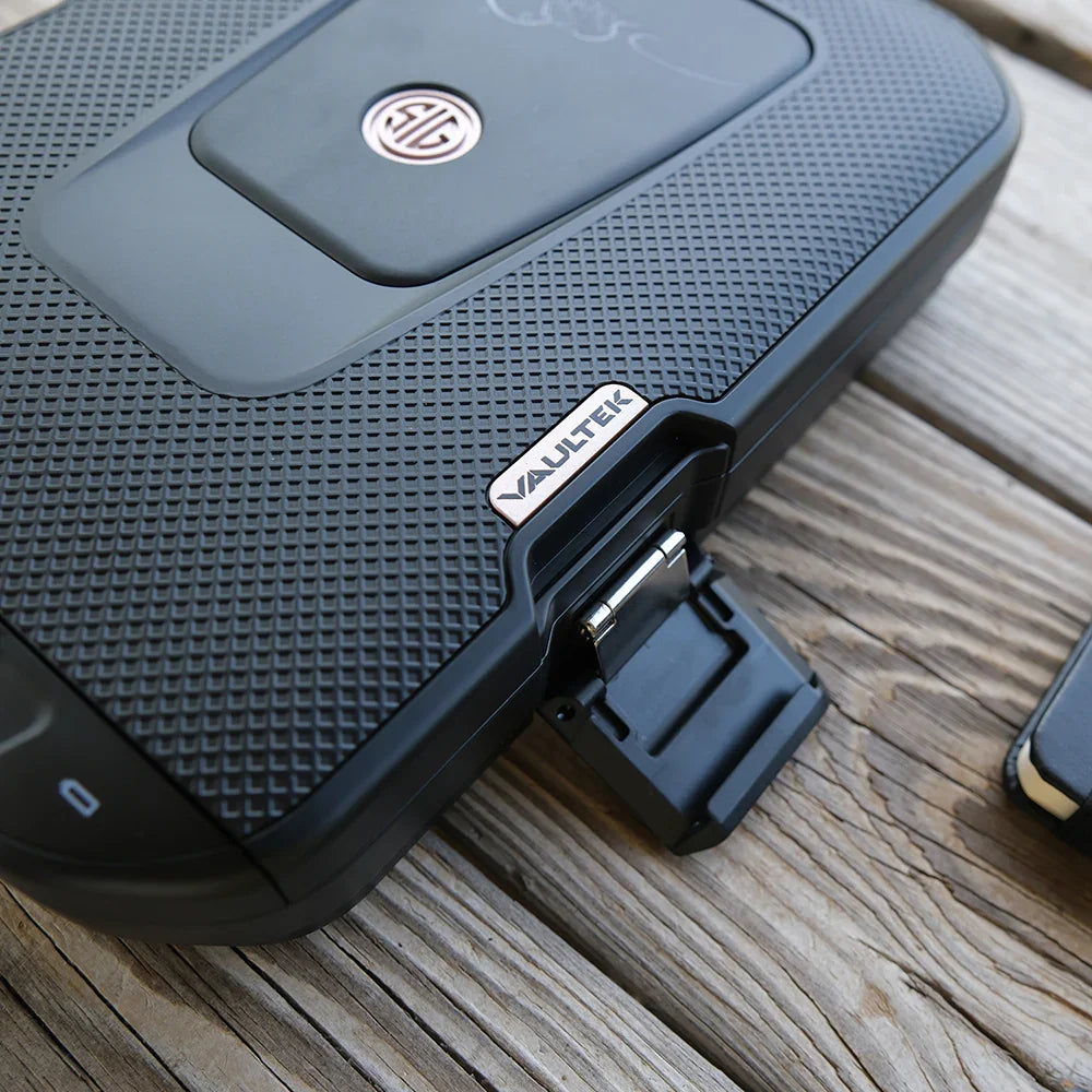 Black biometric portable safe with textured surface on wooden table