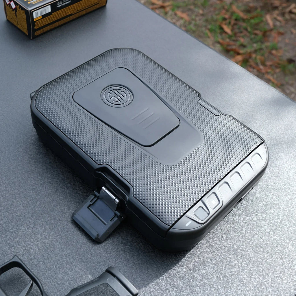 Black biometric portable safe with textured surface and keypad on outdoor table