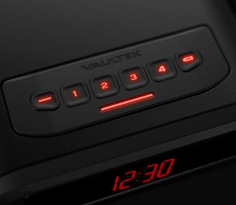 Closeup of digital keypad and clock display on a black biometric safe with red LED lights.