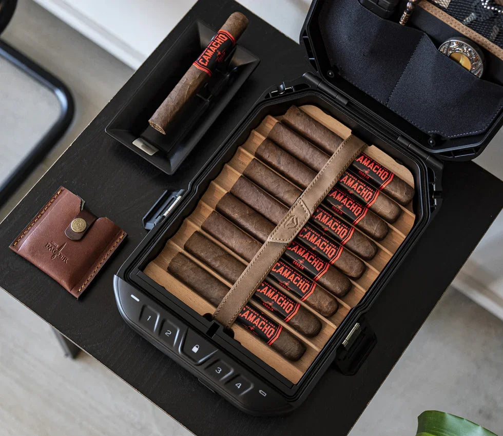 Biometric safe open on table displaying cigars and organized compartments, modern home security.