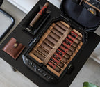 Biometric safe open on table displaying cigars and organized compartments, modern home security.