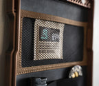 Close-up of a safe door storage panel with mesh pocket and organized compartments