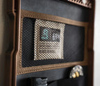 Close-up of a safe interior with mesh pocket, storage pouch, and organized compartments