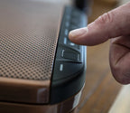 Hand using fingerprint scanner on biometric safe with metal textured surface