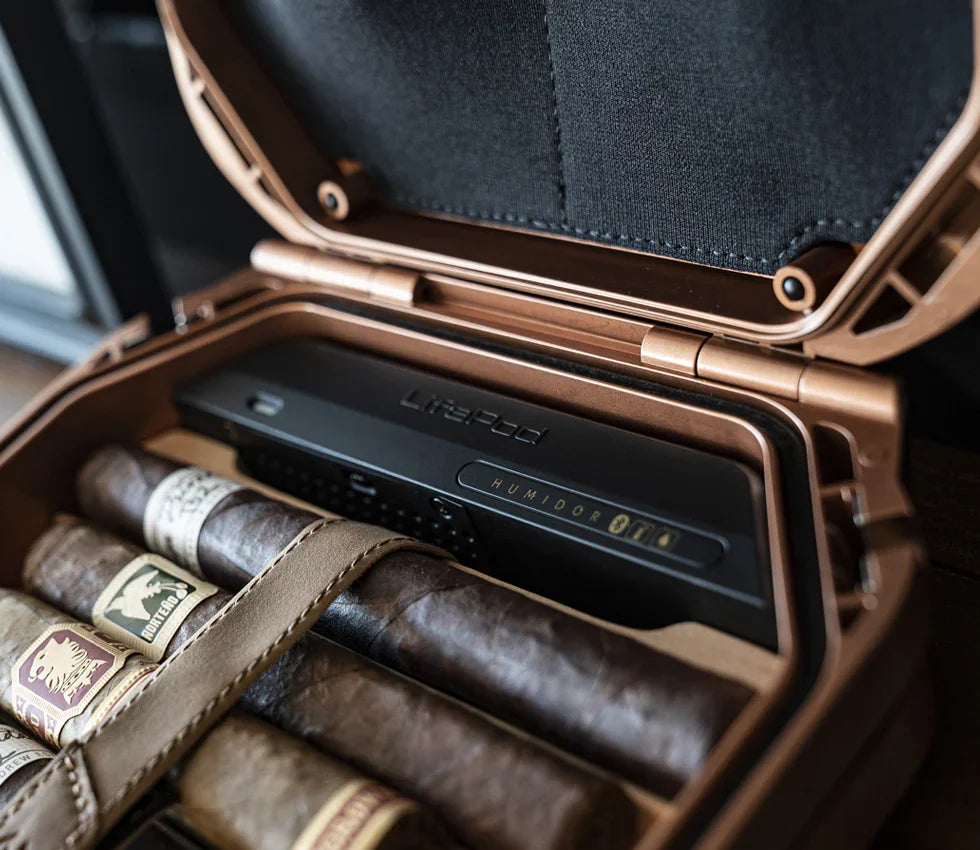Open portable humidor safe displaying cigars inside rugged case on table