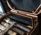 Open portable humidor safe displaying cigars inside rugged case on table