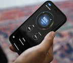 Hand holding smartphone displaying safe humidity and temperature monitoring app