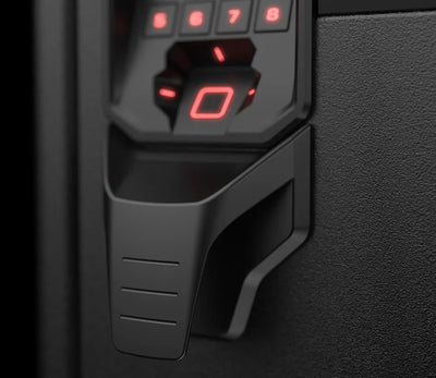 Close-up of biometric safe keypad with illuminated fingerprint scanner and textured surface.