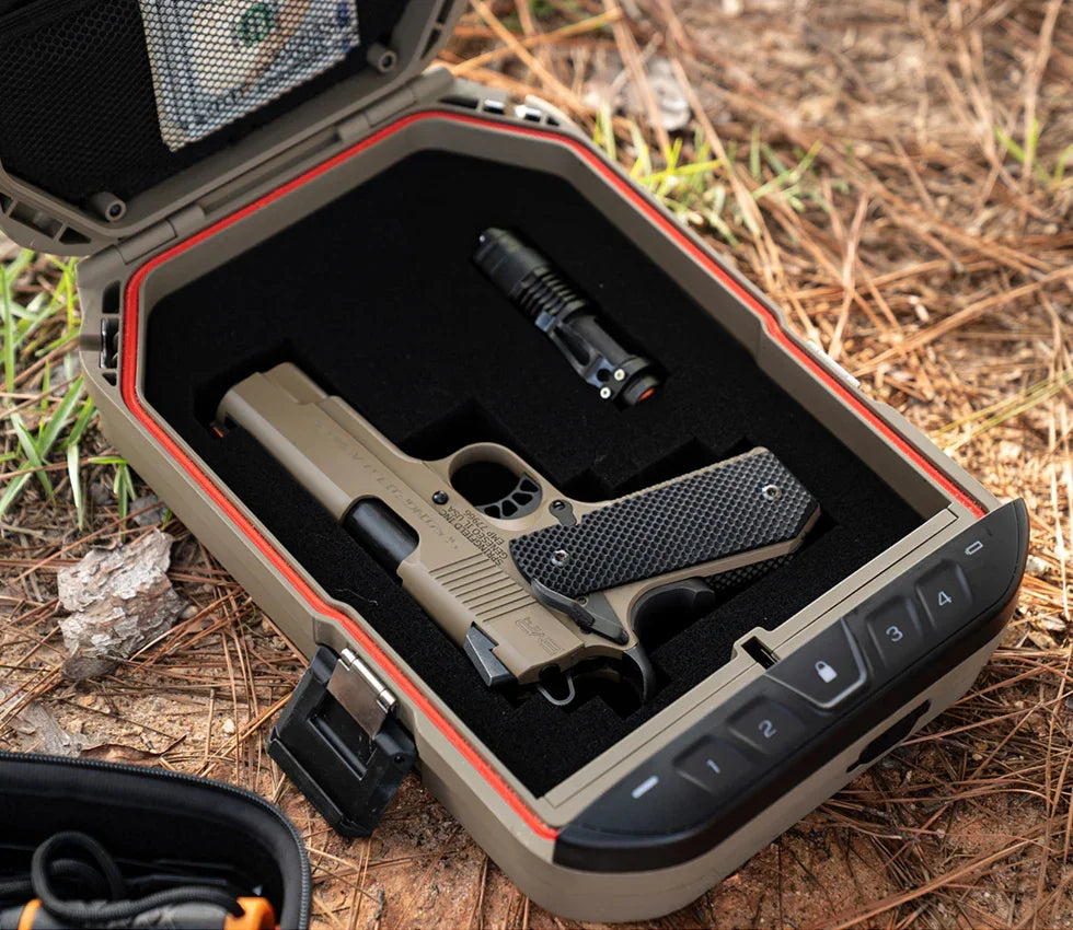 Outdoor biometric safe with foam interior holding a handgun and flashlight