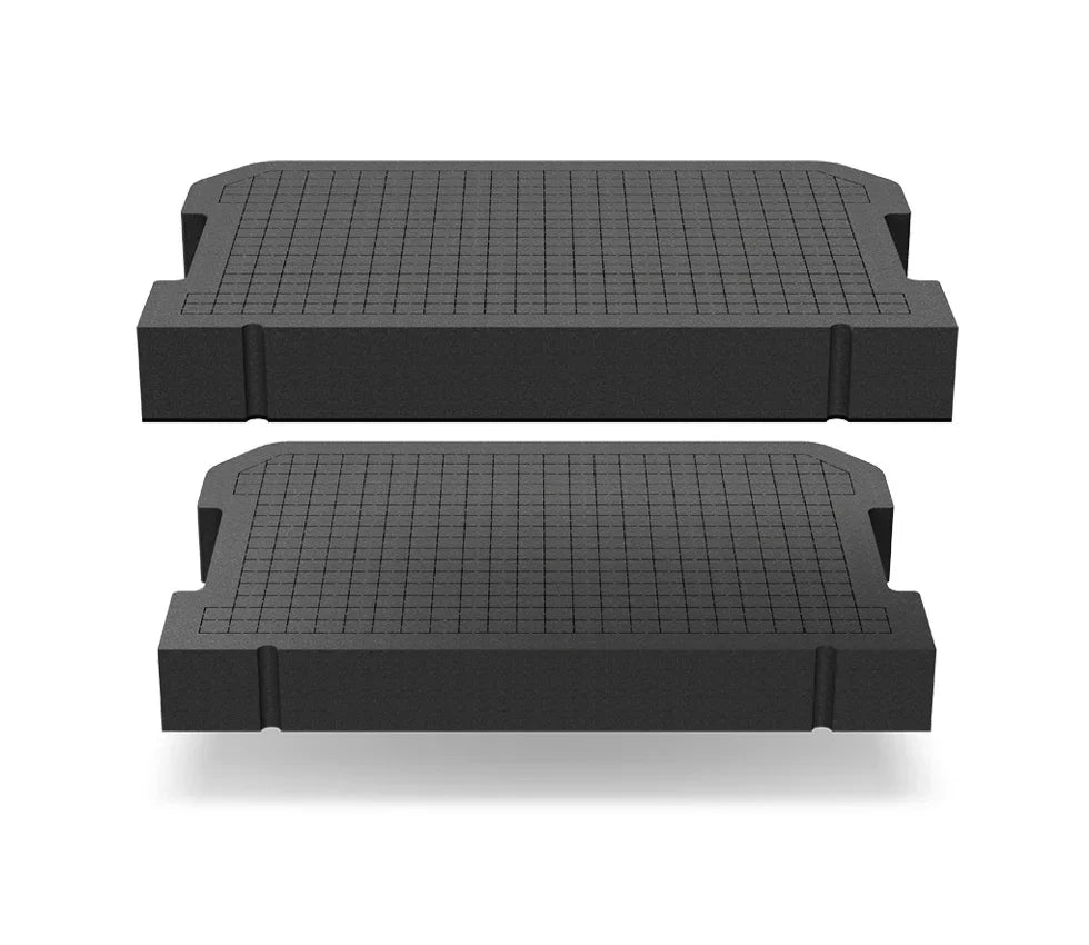 Two black customizable foam inserts with grid pattern for safe or security case interior.