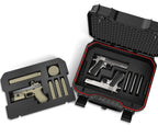 Open black safe with foam insert, holding two pistols and magazine slots, next to empty foam tray.