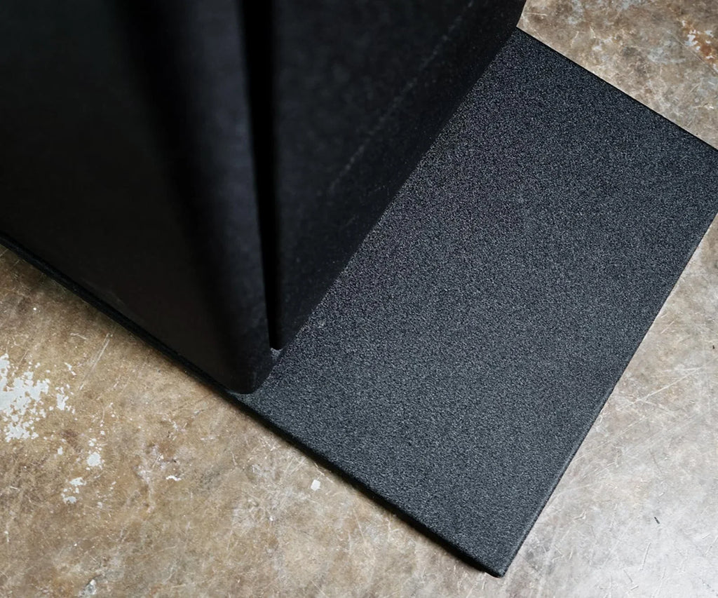 Textured steel safe baseplate installed on a concrete floor