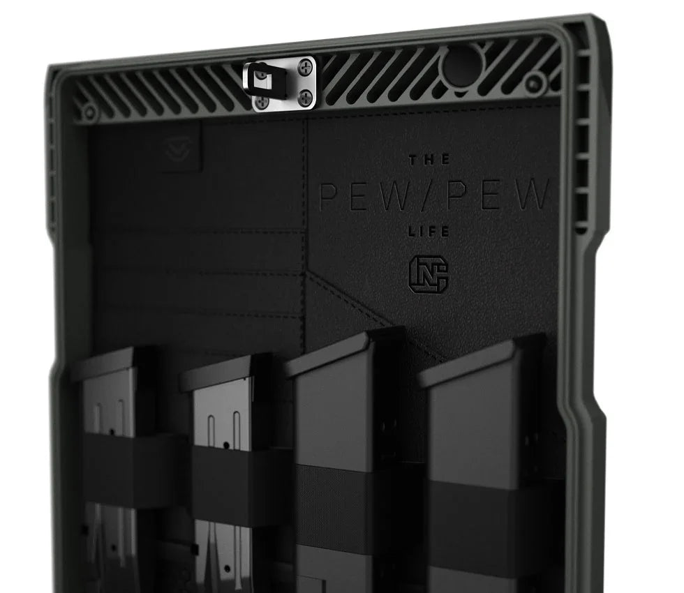 Interior of a rugged safe lid with four magazine holders, tactical storage setup visible.