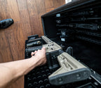 Rifle being removed from secure home gun safe with organized firearm storage racks