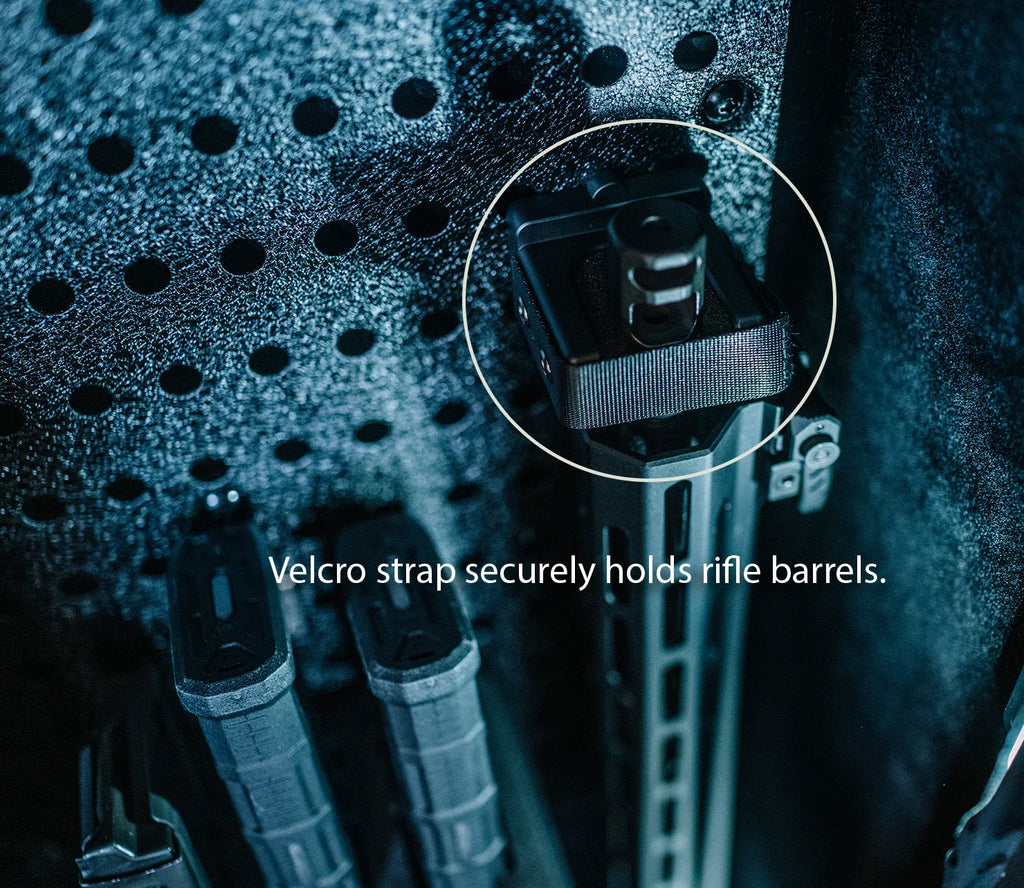 Velcro strap secures rifle barrels inside a textured safe interior with organized storage.