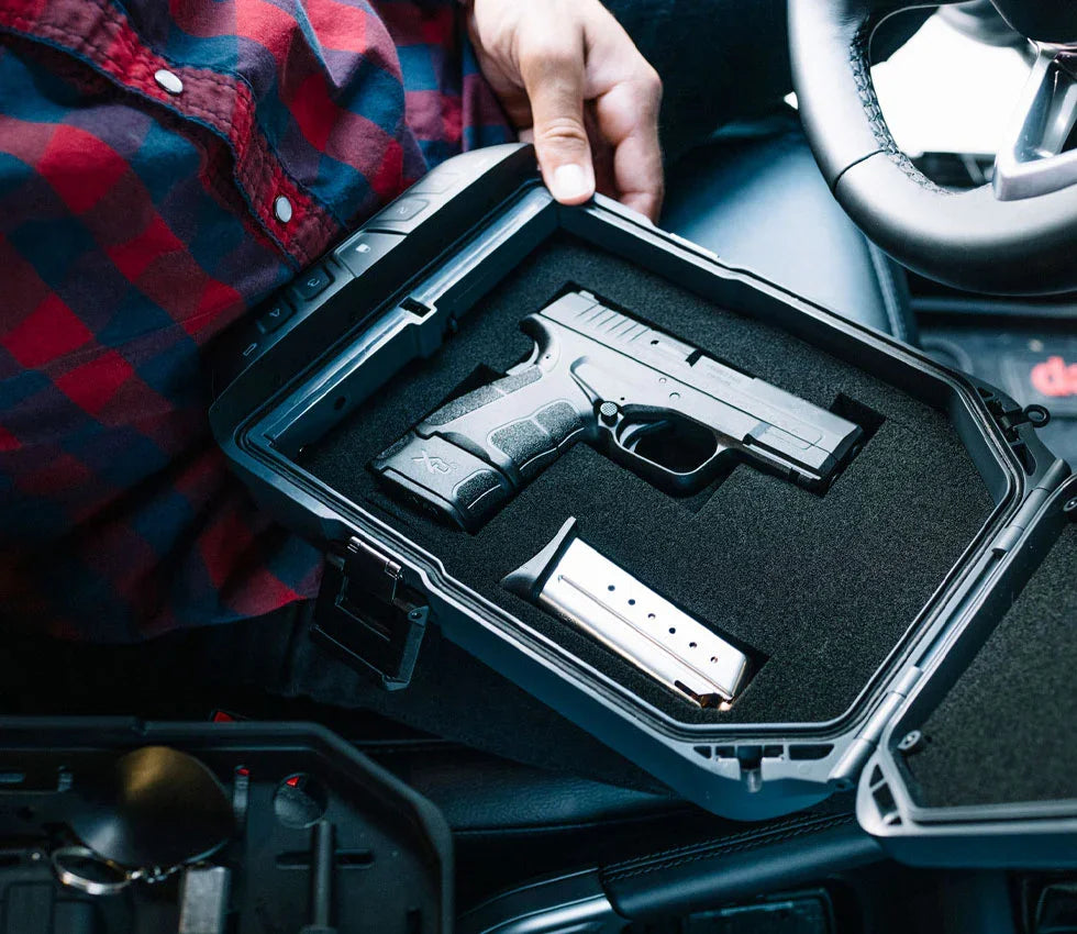 Portable biometric safe with handgun and magazine inside vehicle setting