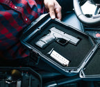 Portable biometric safe with handgun and magazine inside vehicle setting